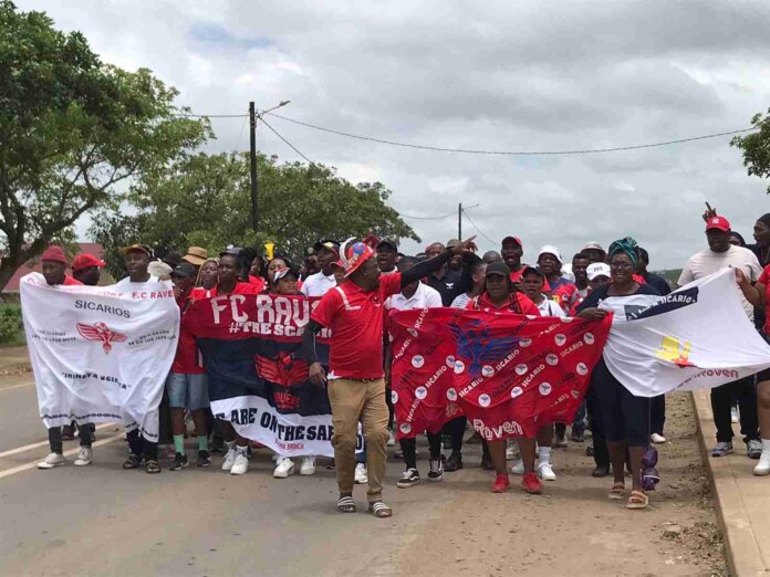 FC Ravans fans cheering and holding team flags