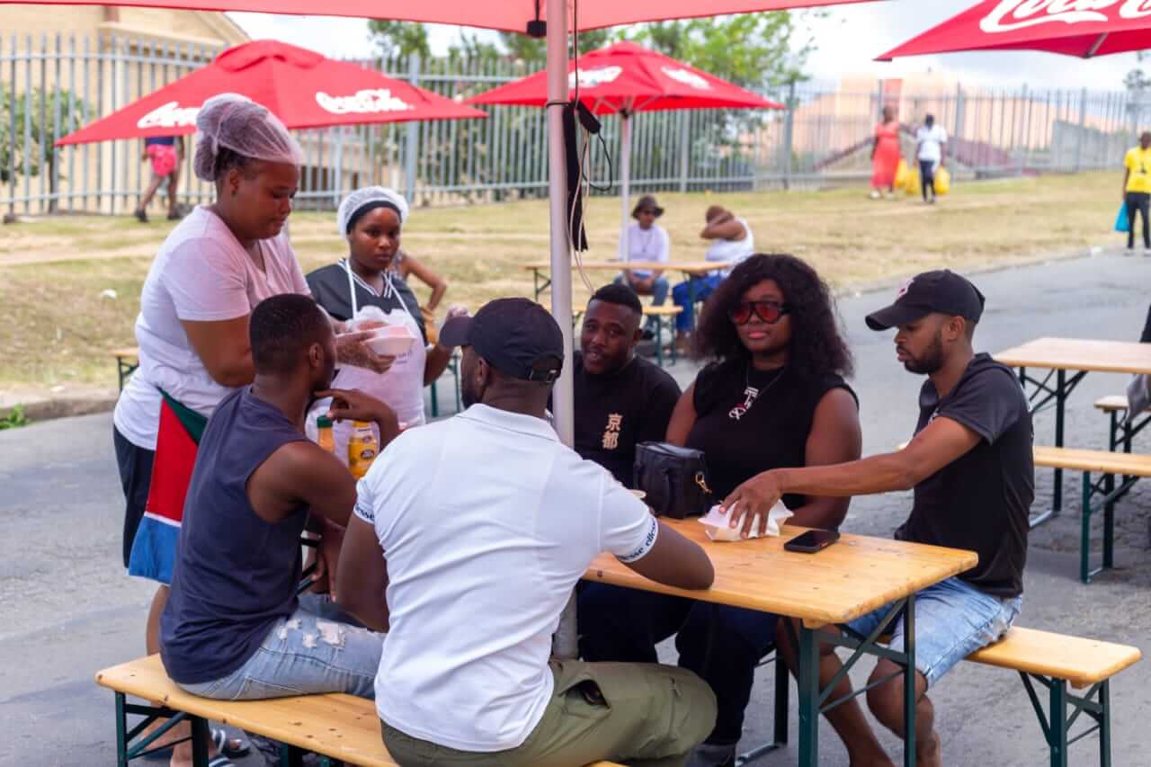 One Of The Vendors Serving Her Customers One of the vendors serving her customers